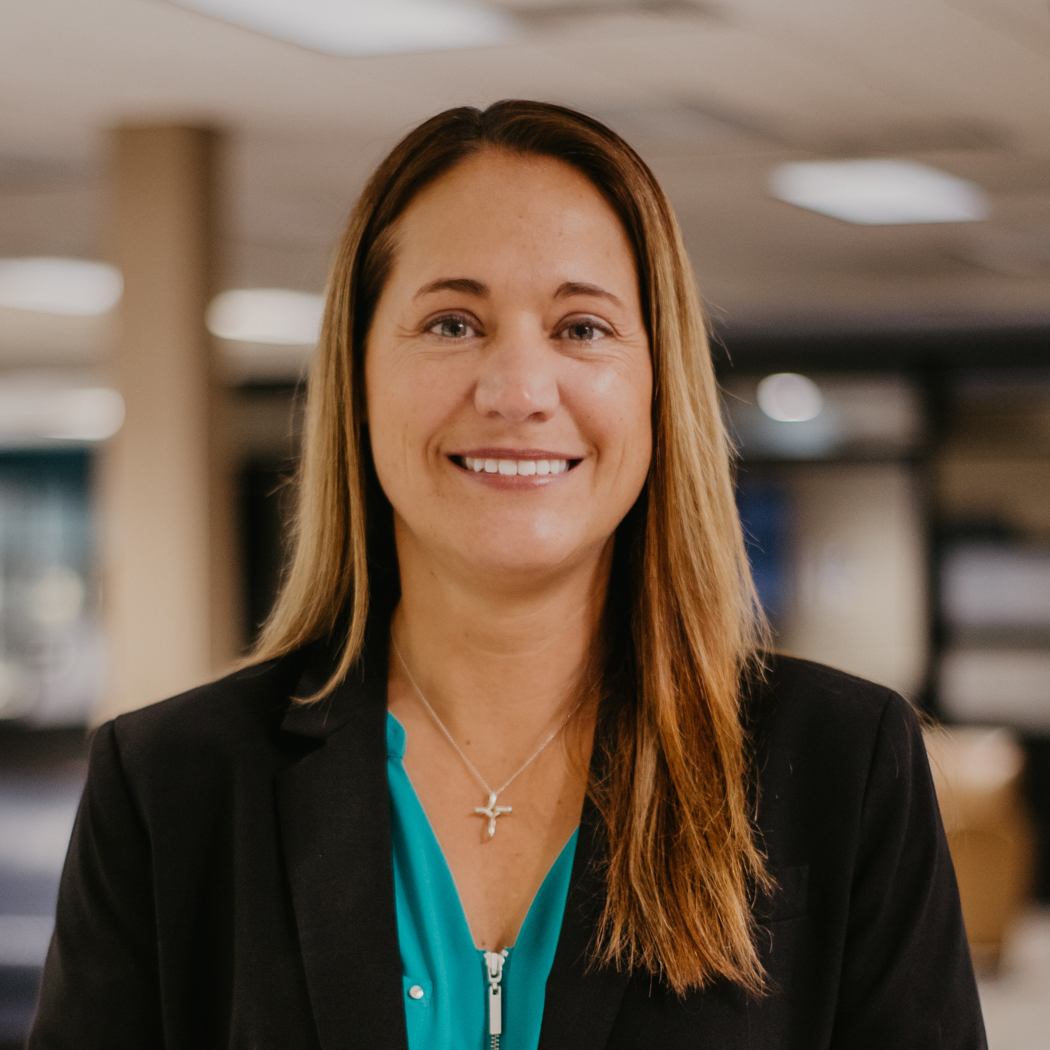 headshot photo of Valerie Schutte in a black blazer and teal blouse